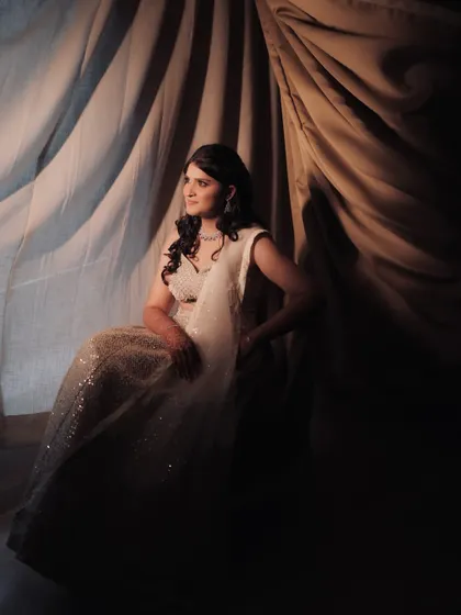 A painterly bridal portrait, using shadows and a draped curtain to create a dramatic, fine-art look.