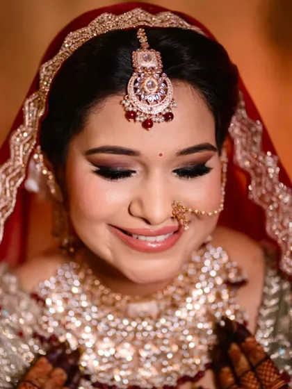 A beautiful smile from my bride. The smokey eye and neutral lip combination is a modern classic that pairs perfectly with her red attire.