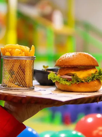 A juicy burger and crispy fries, enjoyed with a view of the colorful ball pit. It's the best of both worlds!