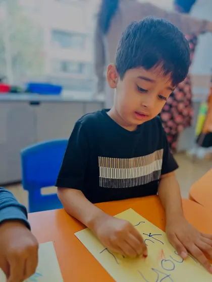 A student practices his writing and coloring skills by making a "Thank You" card. Art can be a powerful tool for teaching social-emotional concepts.