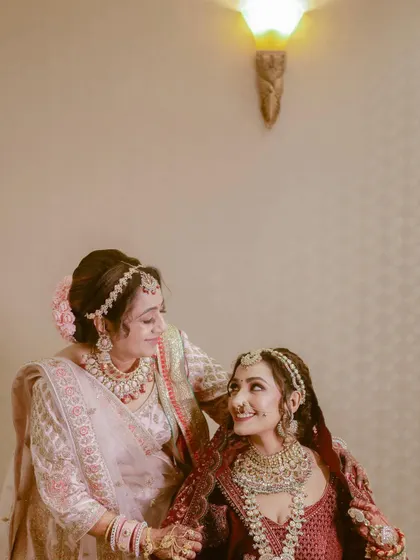 In between all the grand ceremonies, there are quiet moments of connection like this one. We focus on capturing the tender bond between a bride and her mother or sister, creating timeless portraits that you will cherish forever.