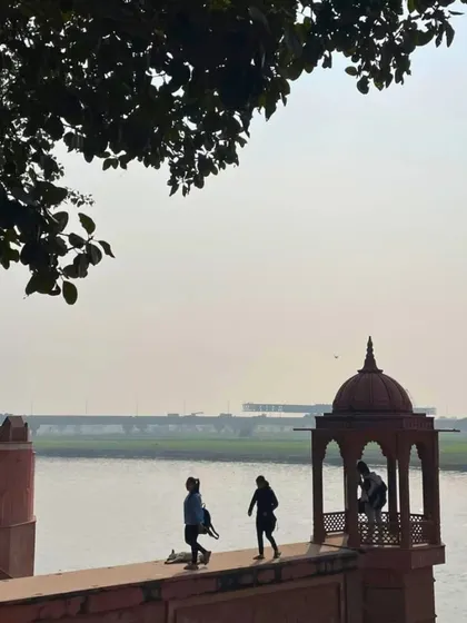 A quiet moment of reflection by the Yamuna river near Agra. This is the serene end to a day of cycling, watching the river flow by historic monuments.