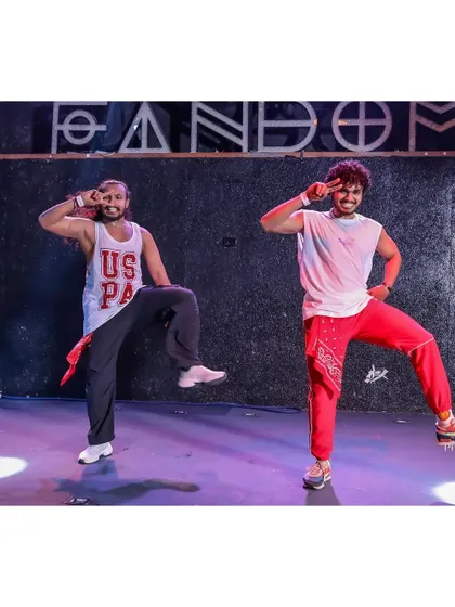 Striking a pose on stage with my dance partner. Our performances are all about high energy and synchronized moves.