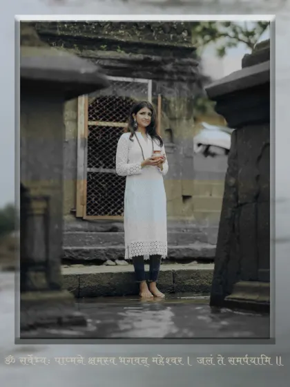 Standing barefoot in the temple courtyard, this shot captures the serene and grounded feeling of devotion during our Shravan-themed portrait session.