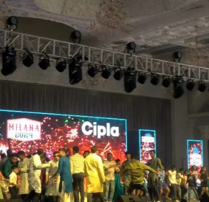 The crowd enjoying the party at the Cipla family day, with the company's branding clearly visible on the LED screen.