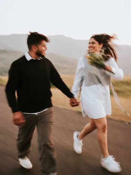 A motion-blur shot of Monil and Charmi running and laughing. This technique adds a sense of energy, fun, and spontaneity to the photograph.