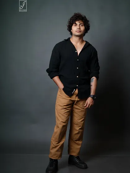A classic male model portfolio shot. The focus here is on a clean, direct look with simple styling, allowing the model's features and confident expression to take center stage. We use precise studio lighting to create this sharp, professional result.