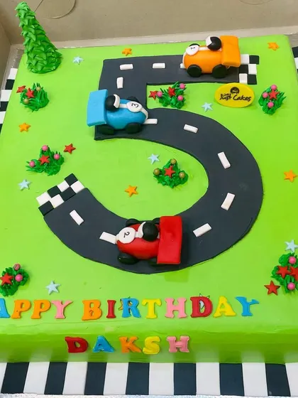A large 5kg sheet cake designed as a number '5' racetrack for a car-themed party.