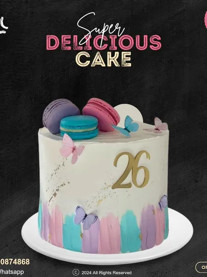 A beautiful cake for a 26th birthday. This design features a pastel watercolor effect, delicate butterflies, and colorful macarons on top, creating a dreamy and elegant look.