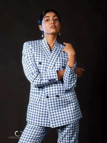A strong, confident stance that showcases the full suit. The clean lines and bold pattern make a powerful statement against the simple black backdrop.