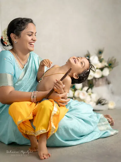 The pure joy on a mother's face as she plays with her little Krishna. His laughter is infectious, making this one of my favorite candid moments from a themed session.
