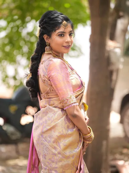 The back view of Harshitha's saree and blouse, showing her lovely hairstyle.