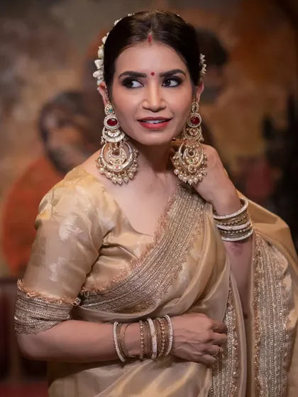 A final portrait showcasing the stunning statement earrings and the classic makeup look.