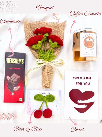 A cozy and warm "hug in a box." This hamper includes a rustic red rose bouquet, a coffee-scented candle, Hershey's dark chocolate, a cute cherry hair clip, and a heartfelt card.