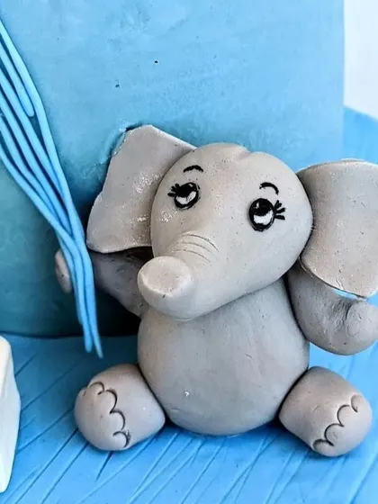 This cute, hand-sculpted baby elephant was the star of a welcome cake for a baby prince. I focus on creating sweet, expressive faces and clean details to bring these little fondant animals to life.