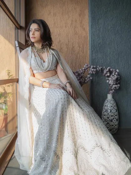 This shot captures the sunlight hitting the sequins on this ivory lehenga, creating a magical, dreamy effect. It’s all about finding the right light to showcase the outfit.