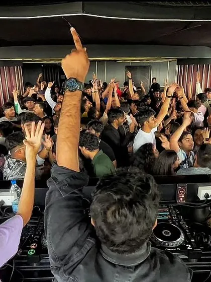My view from behind the decks, with a sea of hands reaching up from the dance floor. This is the connection I strive to create.