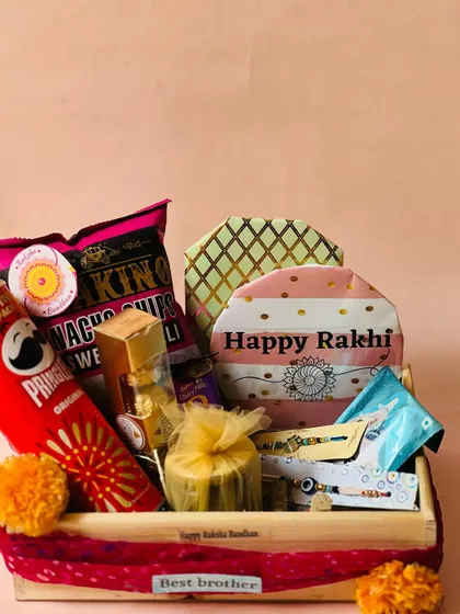 A stylish Rakhi hamper in a wooden tray, perfect for a brother who appreciates a mix of modern snacks and festive flair.