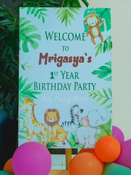 A personalized welcome sign for Mrigasya's first birthday party. The sign features cute, watercolor-style jungle animals and sets a warm, inviting tone for guests as they arrive.
