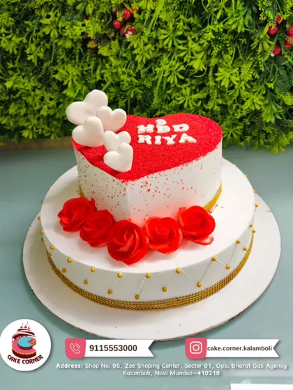A gorgeous two-tier cake with a red velvet heart on top. The red roses and gold accents make it a romantic and luxurious choice for Riya's birthday or an anniversary.