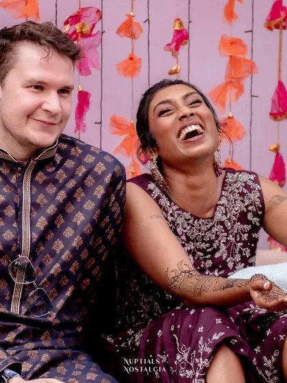 A candid shot of the bride laughing heartily during the Mehendi games, a testament to the fun and relaxed atmosphere of the event.
