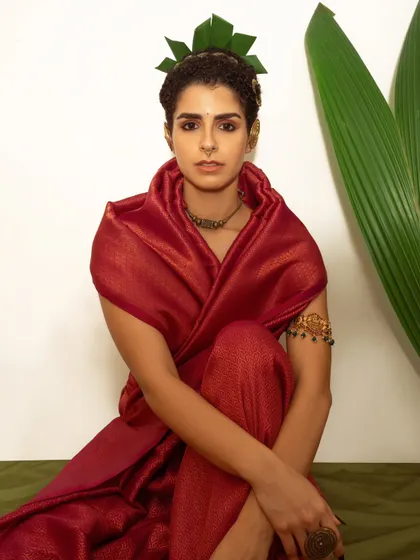 A direct and engaging portrait from a concept shoot blending nature and fashion. The composition highlights the model's expression and the unique, organic styling elements.