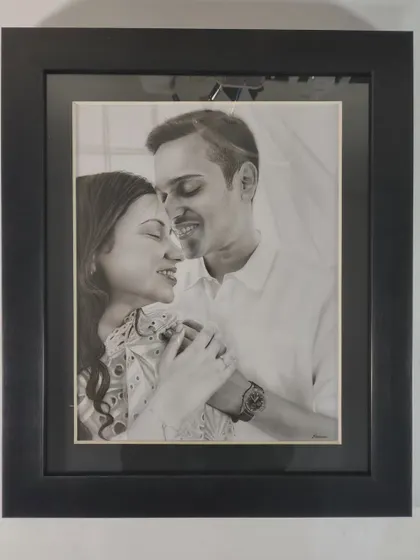 The finished portrait in a classic black frame, ready to be hung. The framing adds a final touch of elegance to the artwork.