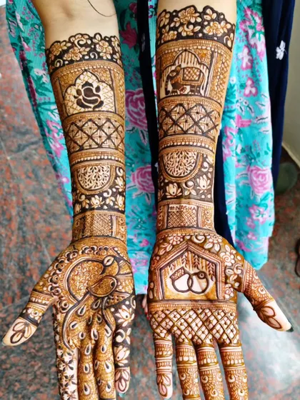 A traditional design for an engagement, featuring a peacock, Lord Ganesha, and wedding rings. The patterns are classic and filled with auspicious symbols for the new beginning.