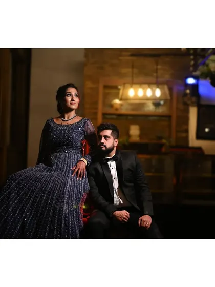 A stylish, posed shot of the couple at their reception, looking like they stepped out of a magazine.