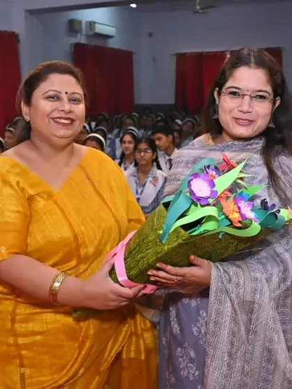 Receiving a bouquet at a school session.