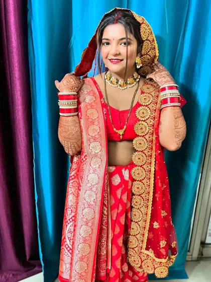 A happy bride is the most beautiful bride. Here, I handled the complete styling, from the classic makeup and hair to the intricate draping of her traditional red Banarasi saree, ensuring she felt comfortable and radiant.