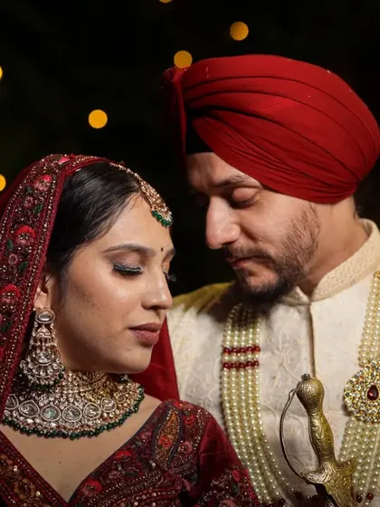 Preserving the cultural richness of a Sikh wedding, this portrait captures the couple in a moment of quiet connection, with beautiful bokeh lights.