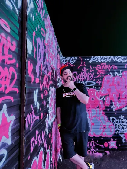 Posing against a graffiti wall in Thailand. The street art culture at Rolling Loud was incredible.