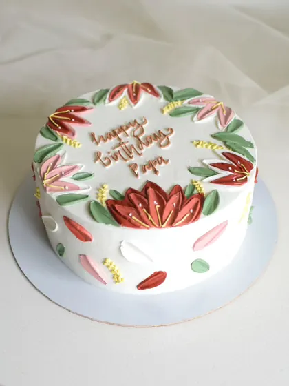 A birthday cake for "Papa" featuring hand-painted lotus flowers. I used a palette knife to create the petals, giving the design a beautiful, impressionistic texture.
