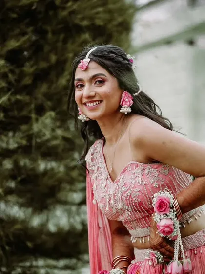 A lovely portrait of a bride at her Haldi or Mehendi, adorned with beautiful floral jewelry.