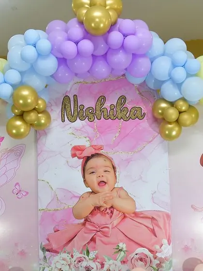 This decor was for an Annaprasana, or first rice ceremony, with a beautiful fairy theme. The backdrop features a large photo of the baby surrounded by pastel balloons and fairy cutouts.