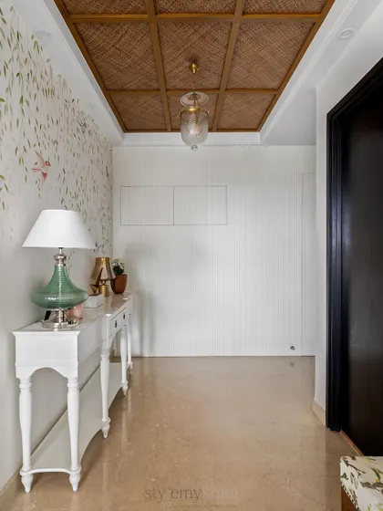 A beautiful foyer, full of love and warmth. The hand-painted bird mural, jute-paneled ceiling, and classic white console create an entryway that is both elegant and welcoming.