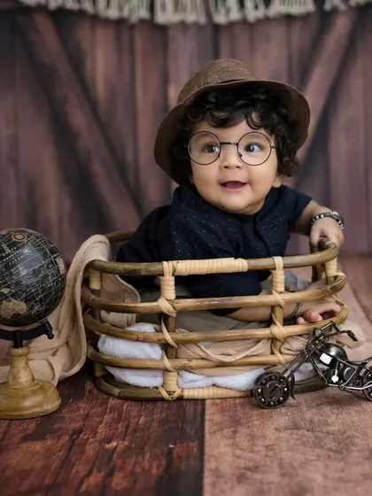 A little scholar in the making. The addition of glasses adds a touch of fun and whimsy to this adorable six-month milestone session.