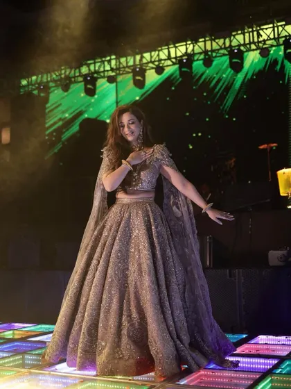 A bride's solo on a stunning LED dance floor. The lighting and her graceful moves came together to create a truly mesmerizing performance for her sangeet.
