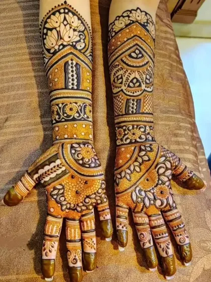 A mirror-image design on both arms with a prominent lotus motif at the top. The combination of bold outlines and delicate shading gives this design a lot of depth.