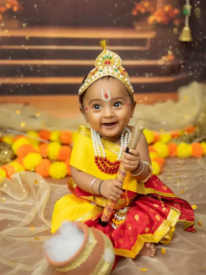 The happiest little Krishna with a big smile, sitting by his pot of butter. This is from a sitter session for an older baby.