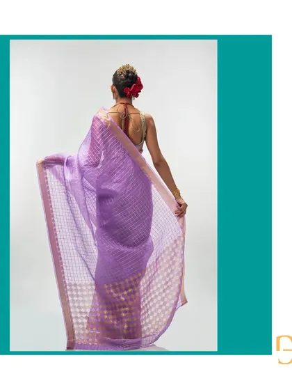 The back view of the African Violet organza saree showcases the sheer, lightweight nature of the fabric and the intricate geometric and floral patterns of the pallu.