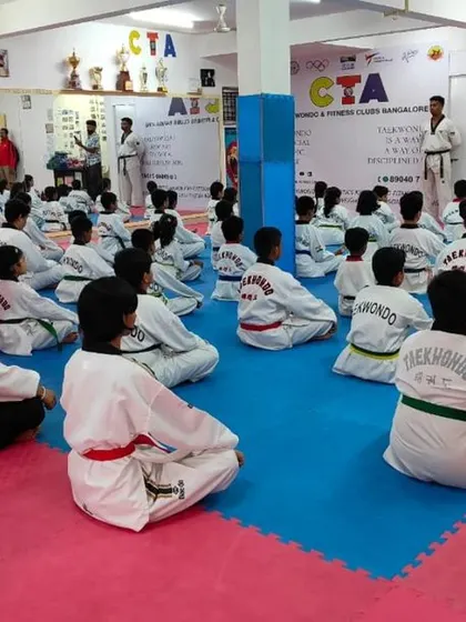 A wide view of the dojang during a belt exam, with students seated and ready.