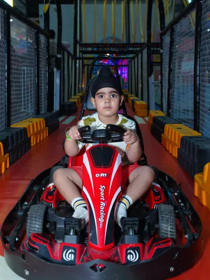 A very young racer looking adorable and ready for his first go-karting adventure.
