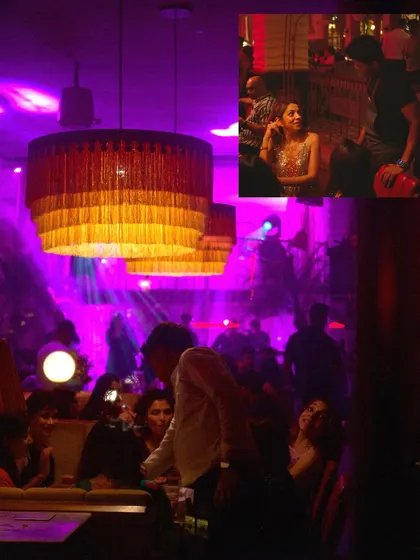 A candid shot from a SWITCH Friday, showing guests enjoying the music and the vibrant, purple-lit ambiance.