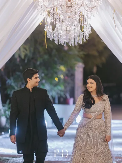 The couple's entrance under a grand crystal chandelier. Simple, elegant, and incredibly romantic, this is a timeless way to make an entrance.