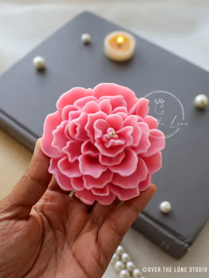 Holding one of my pink floating Camellia candles. You can really see the delicate, double-pleated petal design that makes this flower so special. It feels wonderful to hold a piece you've poured so much care into.