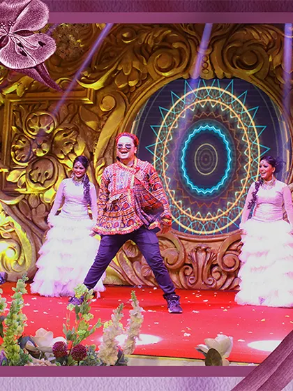 A snapshot of a vibrant sangeet performance we choreographed. The energy of the dancers is matched by the ornate stage backdrop and dynamic lighting we designed for the event.