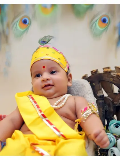 A sweet close-up of a 4-month-old baby during his first Krishna photoshoot. We are skilled at safely posing and photographing even the youngest infants.