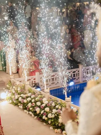 The bride's entrance, celebrated with a line of cold pyros as the groom watches, creating a sparkling and dramatic welcome.